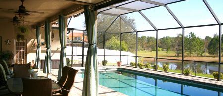 Pool enclosure surrounding a pool and sitting area