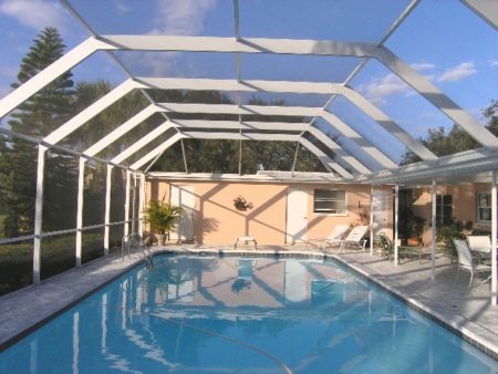 A pool enclosure surrounding a backyard pool in Seminole, FL 