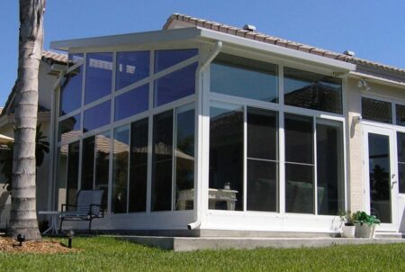 Sunroom addition with white rain gutters
